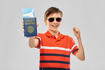 Image showing happy boy with air ticket and immunity passport