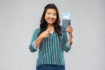 Image showing asian woman with air ticket and immunity passport