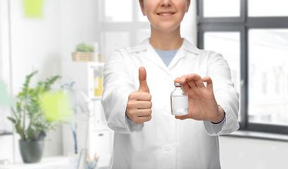 Image showing doctor with medicine showing thumbs up at hospital