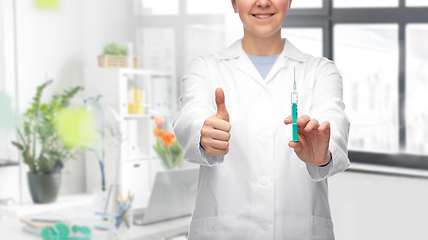 Image showing doctor with syringe showing thumbs up at hospital