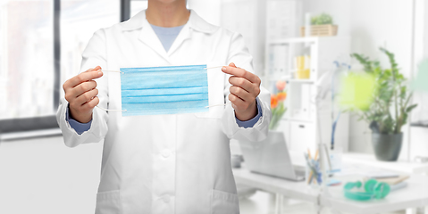 Image showing female doctor showing medical mask at hospital