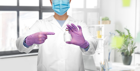 Image showing doctor in mask with medicine at hospital