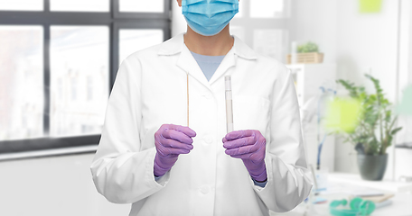 Image showing female doctor with test tube and cotton swab