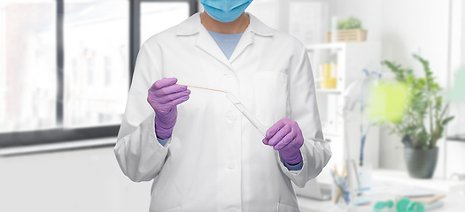 Image showing female doctor with test tube and cotton swab