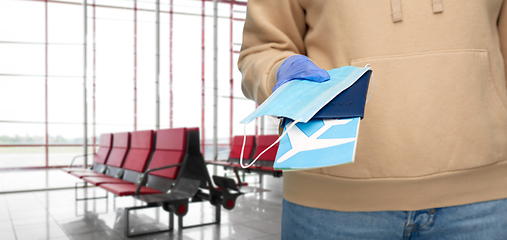 Image showing woman with mask, passport and ticket at airport