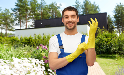 Image showing male worker or cleaner in gloves at garden
