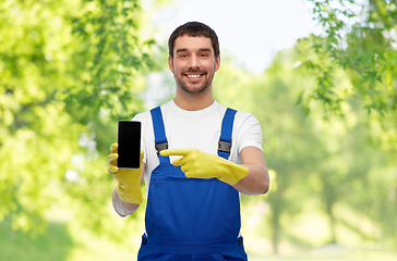 Image showing happy male worker or cleaner showing smartphone