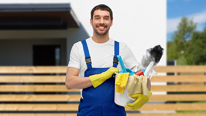 Image showing male cleaner in overall with cleaning supplies