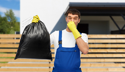 Image showing male worker or cleaner with stinky garbage bag