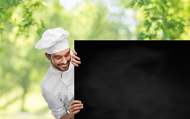 Image showing happy smiling male chef with big black chalkboard