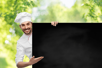 Image showing happy smiling male chef with big black chalkboard