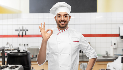 Image showing happy smiling male chef showing ok at kitchen