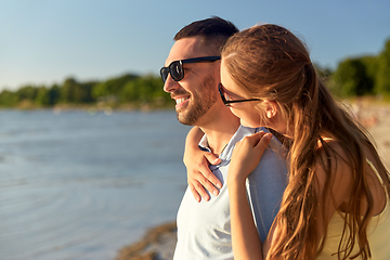 Image showing happy couple hugging on summer beach