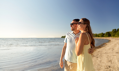 Image showing happy couple hugging on summer beach