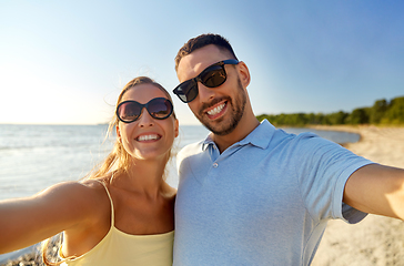 Image showing happy couple taking selfie on summer beach