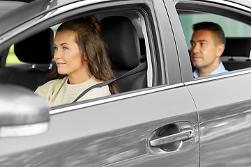 Image showing female driver driving car with male passenger