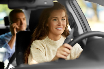 Image showing female driver driving car with male passenger