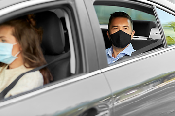 Image showing female driver in mask driving car with passenger