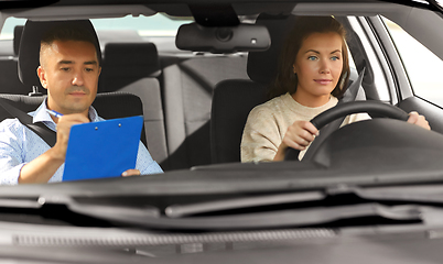 Image showing car driving school instructor and young driver