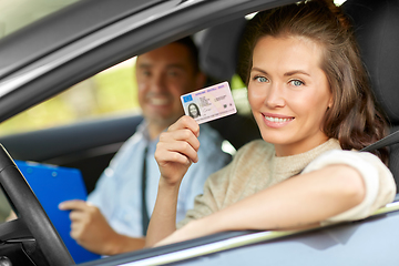 Image showing car driving instructor and driver with license