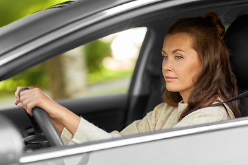 Image showing woman or female driver driving car in city