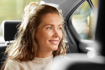 Image showing happy smiling woman or female passenger in car