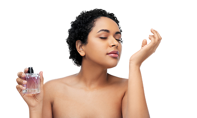 Image showing young african american woman smelling perfume