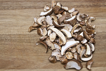 Image showing piled dried birch polypore on cutting board with copy space