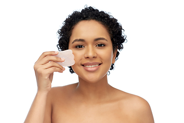 Image showing happy woman massaging her face with gua sha tool