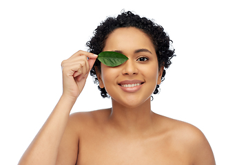 Image showing portrait of african american woman with green leaf