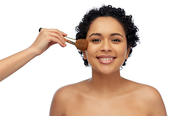 Image showing happy woman and hand of make up artist with brush