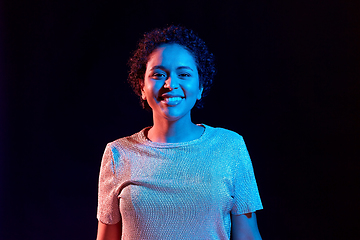 Image showing african woman over neon lights on black background