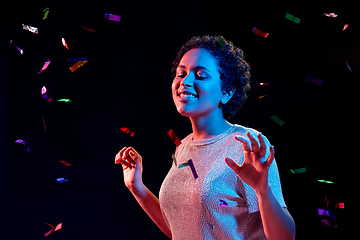 Image showing african woman under confetti at nightclub party