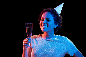 Image showing african woman in party cap with glass of champagne