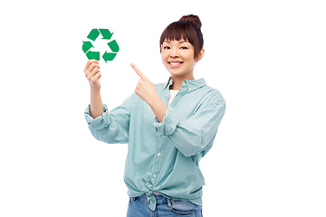 Image showing smiling asian woman holding green recycling sign