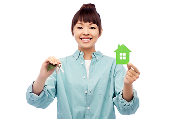 Image showing smiling asian woman holding green house and keys