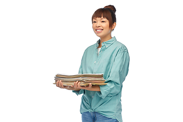 Image showing smiling young asian woman sorting paper waste