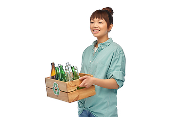 Image showing smiling young asian woman sorting glass waste