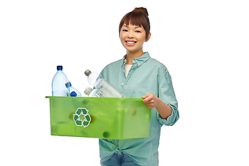 Image showing smiling young asian woman sorting plastic waste