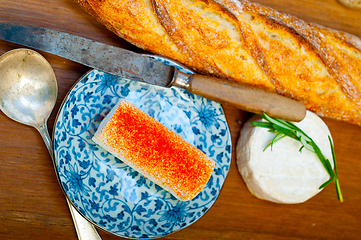 Image showing French cheese and fresh  baguette on a wood cutter