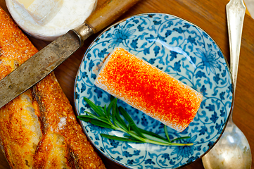 Image showing French cheese and fresh  baguette on a wood cutter