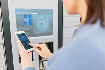 Image showing woman with smartphone at automated parcel machine