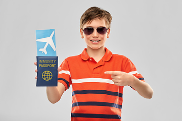 Image showing happy boy with air ticket and immunity passport