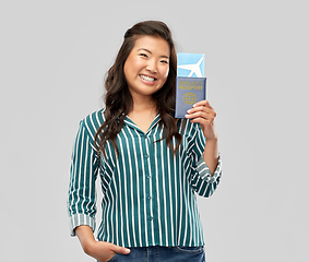 Image showing asian woman with air ticket and immunity passport