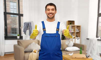 Image showing happy male worker or cleaner in gloves at home