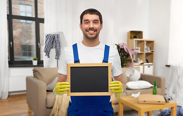 Image showing male worker or cleaner with chalkboard at home