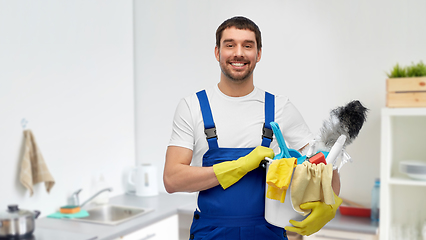 Image showing male cleaner with cleaning supplies at kitchen