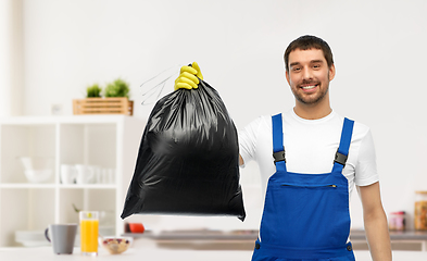 Image showing male cleaner showing garbage bag at home kitchen