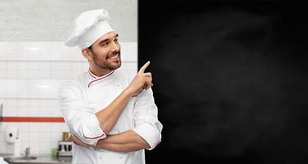 Image showing happy smiling male chef with big black chalkboard