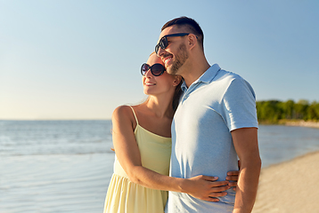 Image showing happy couple hugging on summer beach